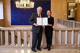 Academy President Markus Schwaiger presents the certificate to award winner Iryna Klymenko.