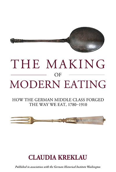 Buchcover. Ein alter Löffel und eine Gabel mit verziertem Griff über und unter dem Titel 'THE MAKING OF MODERN EATING HOW THE GERMAN MIDDLE CLASS FORGED THE WAY WE EAT, 1780-1910'